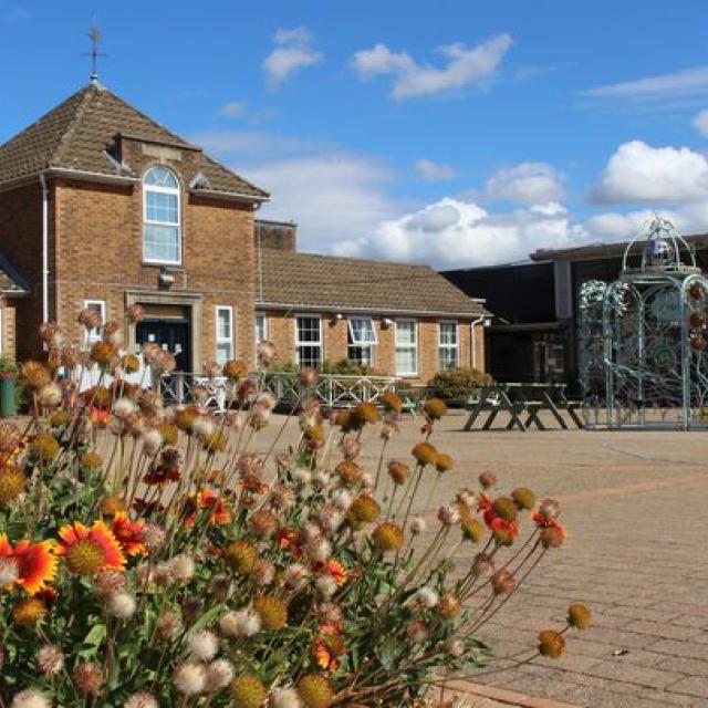 Treloar College Piazza looking towards the Blacksmith's archway, with orange flowers in foreground