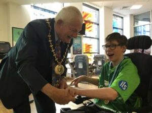 Student receiving medal from the mayor at the Swimming Gala