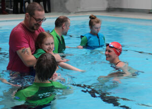 Suzanna Hext swimming with students and staff