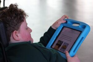 Student using his iPad to solve a riddle