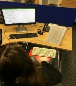 Student at a desk during her work experience in a school office