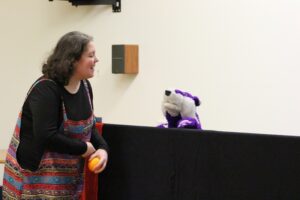 An actor talking to one of the puppets.