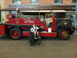 Primary student in the Milestones Museum in front of an old fire truck