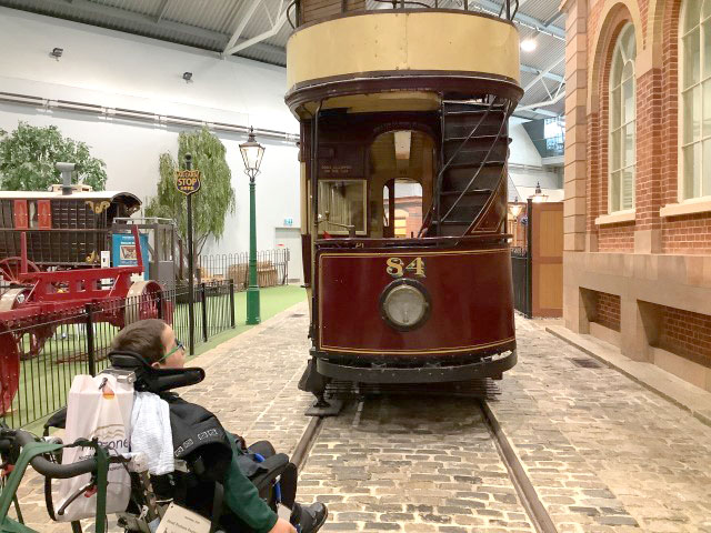 Student looking at an old train in the Milestones Museum