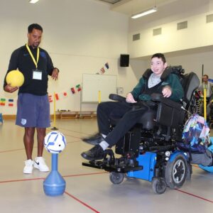 Martin Sinclair coaching a student in a wheelchair
