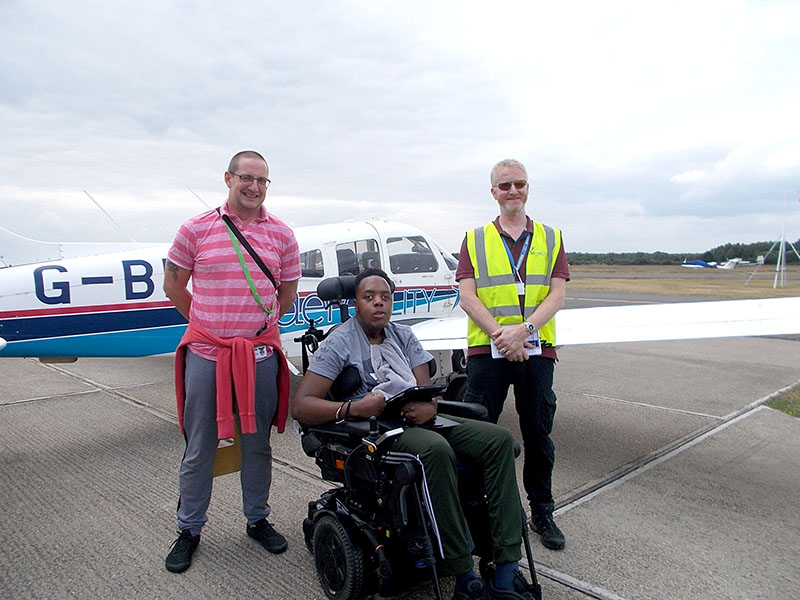 Photos at Aerobility of treloar College student with staff in front of the plane
