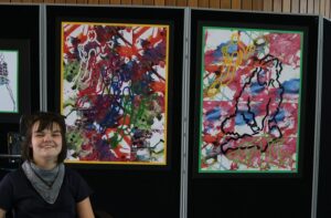 Student in front of her art work
