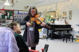 Kate Read, a professional viola player, performing in the classroom and interacting with Treloar's student