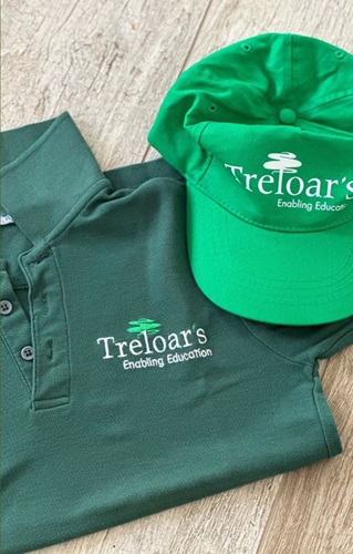 Dark green uniform T-shirt with a bright green cap - both with Treloar's branding on