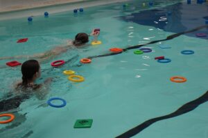 Day of Disability Sports at Treloar's: students in the pool fishing out plastic balls and hoops
