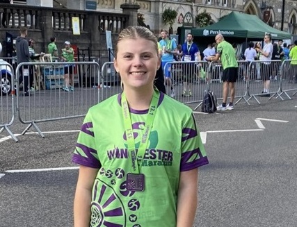 Lauren after finishing the Winchester Half-Marathon - wearing a green T-shirt.